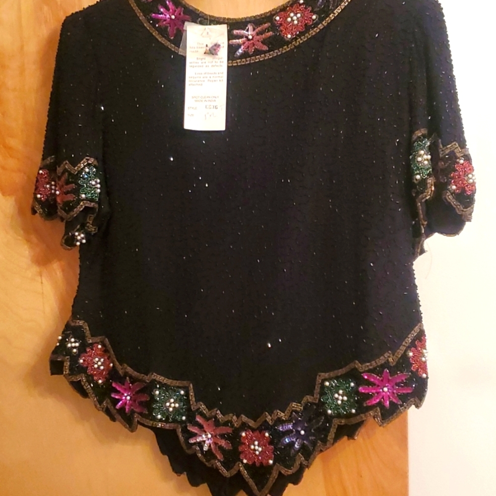 New with style tag. Black sequined top. Perfect, never worn. Laurence Kazar.PXL